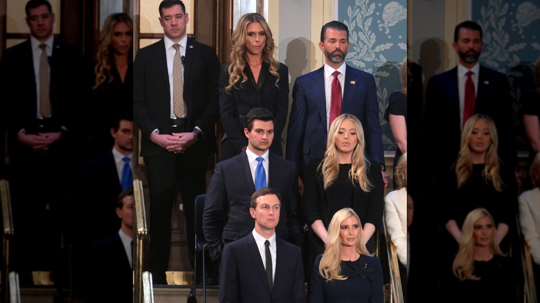 Bettina Anderson and Donald Trump Jr. stand outside the Capitol behind other members of the Trump family.
