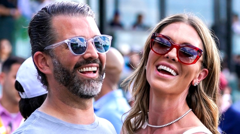 Close-up of Donald Trump Jr. and Bettina Anderson laughing at an outdoor event.