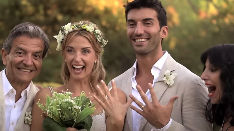 Justin and Emily Baldoni posing with guests at their wedding.