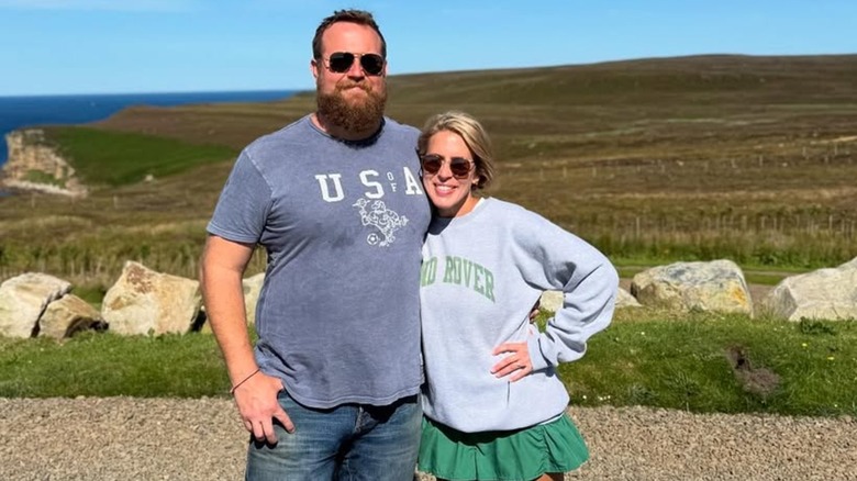 Erin and Ben Napier posing near the ocean