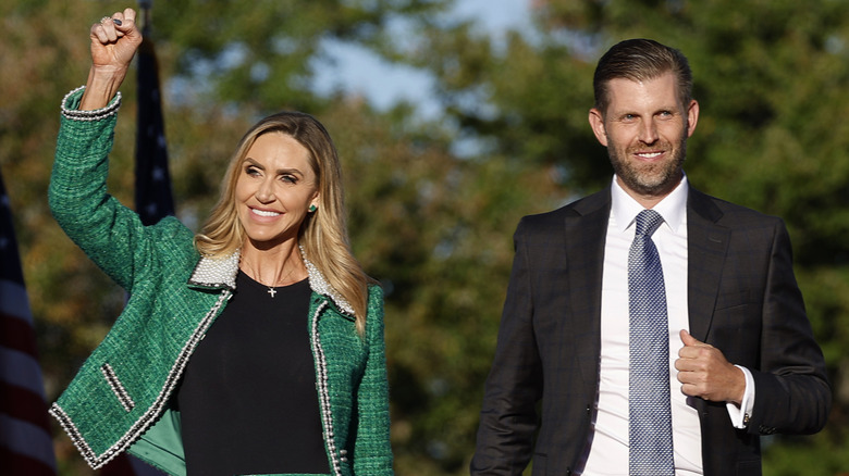 Eric and Lara Trump walking separately at a political rally.