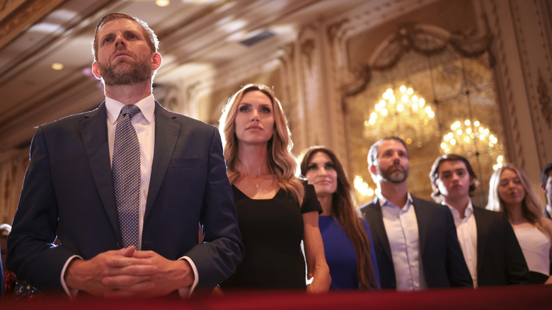 Eric and Lara Trump standing with other members of the Trump family.
