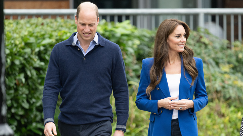 Prince William and Kate Middleton walking together and smiling