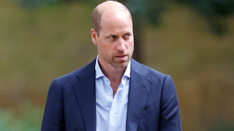 Prince William wearing a dark-blue suit jacket over a light-blue button-up shirt