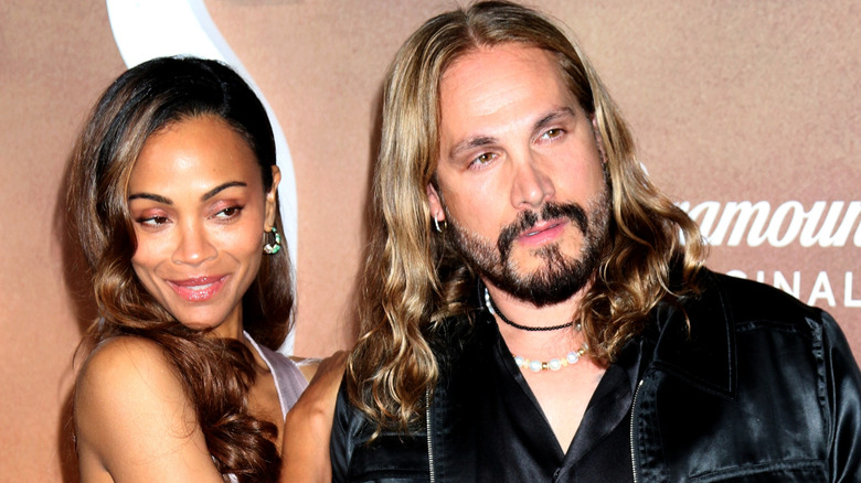 Zoe Saldaña and Marco Perego-Saldaña hugging on the red carpet.