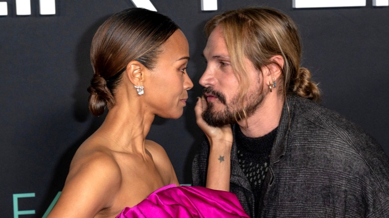 Zoe Saldaña and Marco Perego-Saldaña stare into each others' eyes on the red carpet.