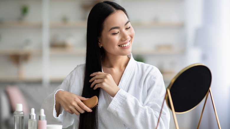 woman brushing healthy hair