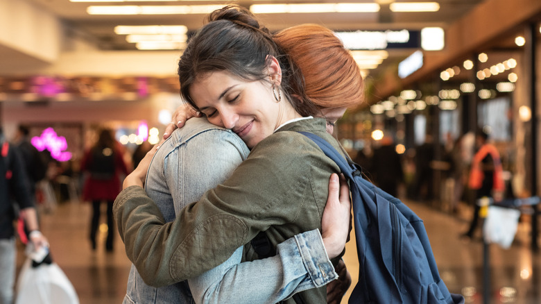 two women hugging at airport