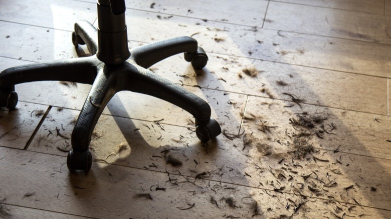 A dirty floor in a hair salon