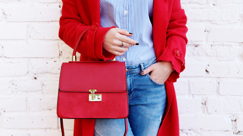Red handbag and jacket paired with soft denim