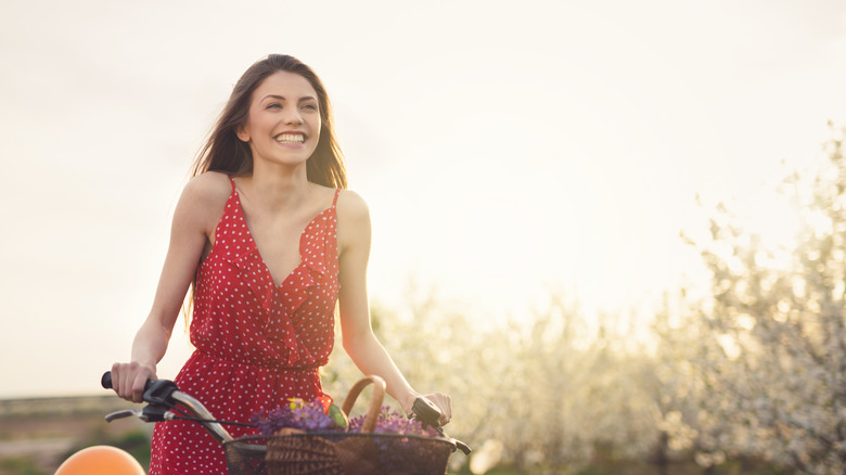Woman on bike wearing red dress