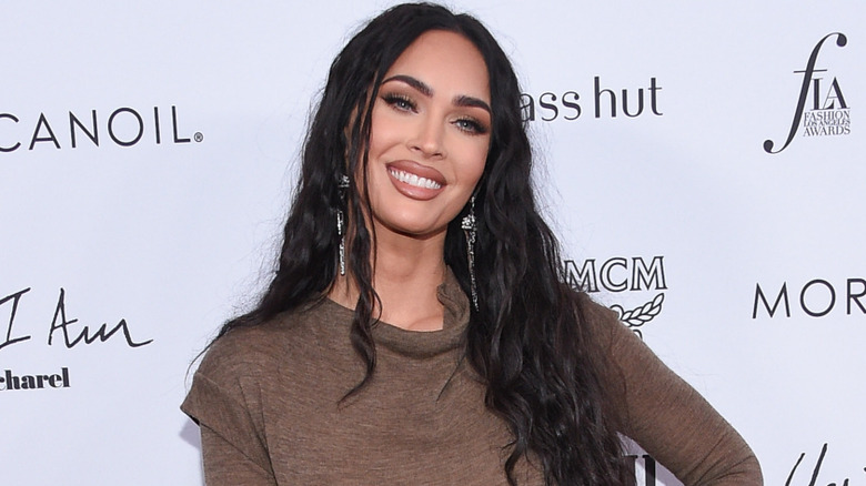 Megan fox wearing a brown dress while posing for a photo at the Daily Front Row Awards on