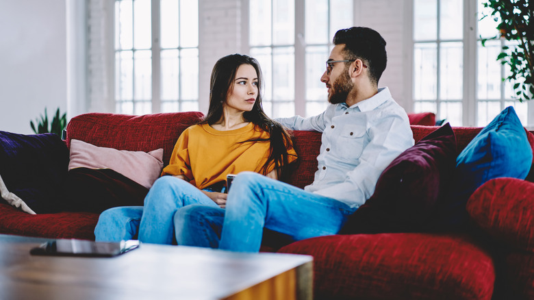Couple talking on couch