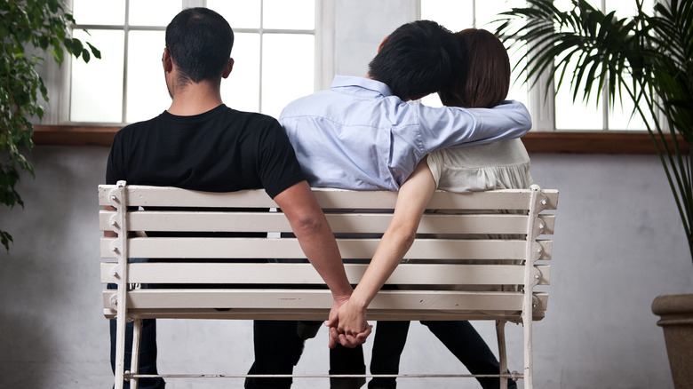 unfaithful couple holding hands