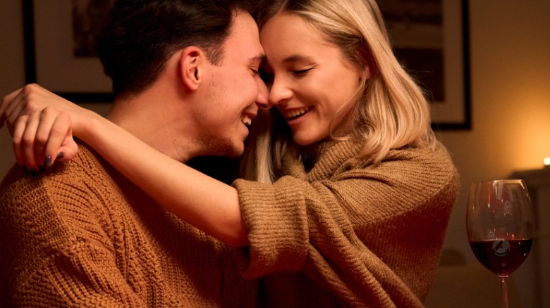 Couple kissing at dinner table