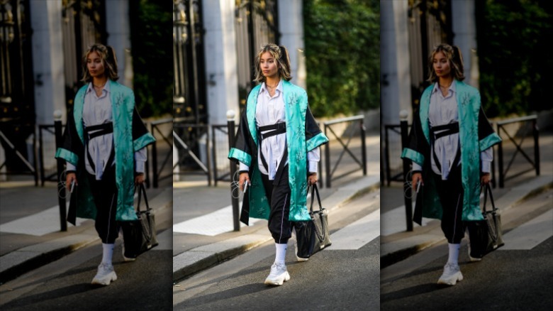 Woman wearing kimono, joggers, sneakers