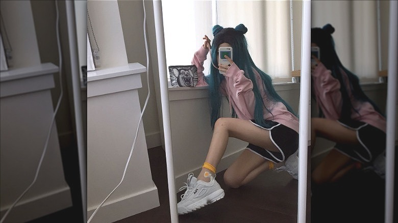 woman wearing track shorts and sweatshirt