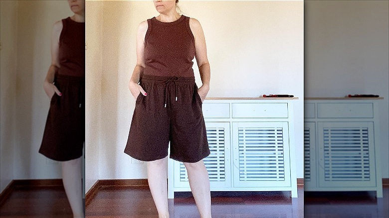 woman wearing long brown track shorts