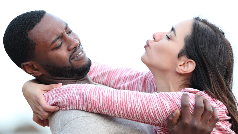 man pulling away from woman