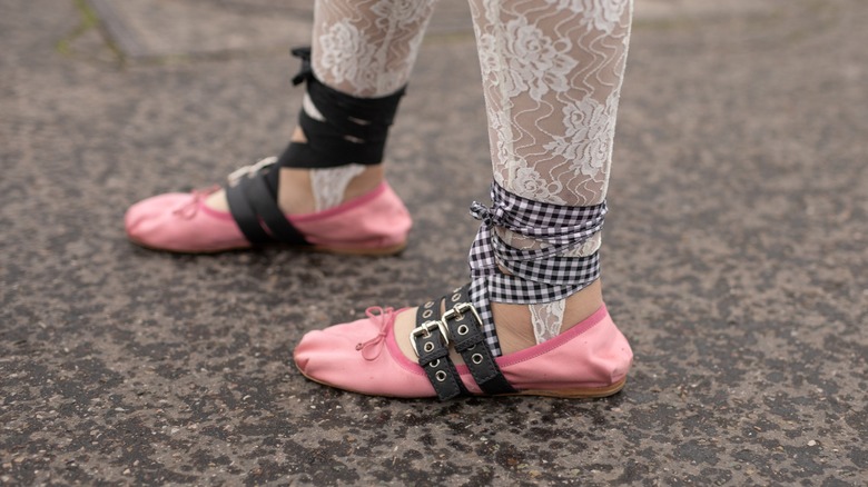 Person wearing ribbon around ballet flats