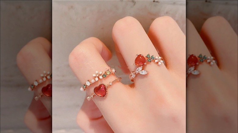 woman wearing thin floral rings