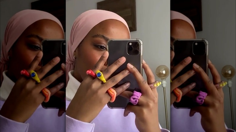 woman's hand wearing clay fashion rings