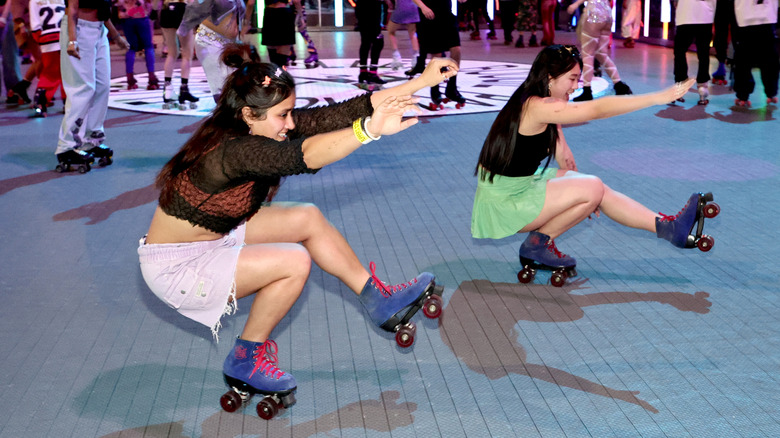Women smile while rollerskating