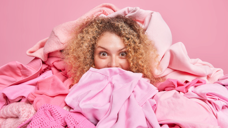 woman in pile of pink clothes
