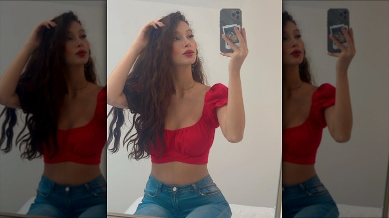 Red crop top with high-waisted jeans