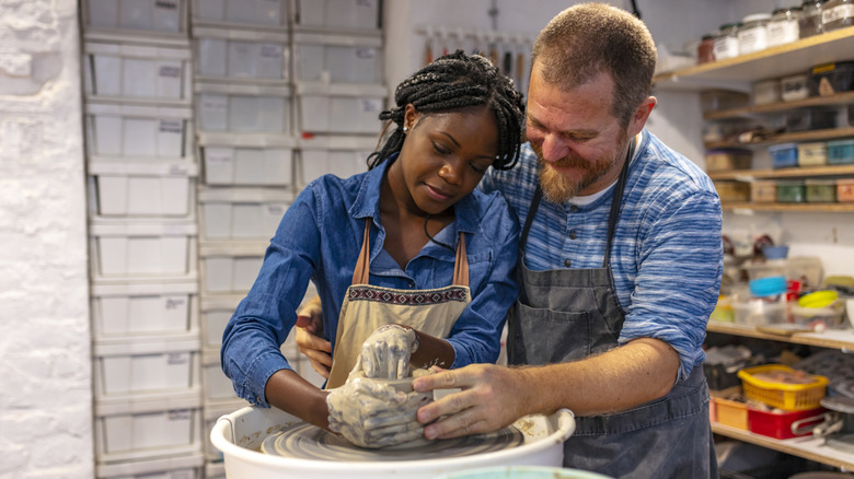 Couple taking pottery class