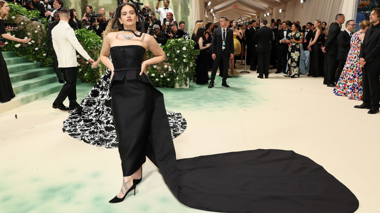 Rosalia wearing a black dress with a sheer face covering at the 2024 Met Gala