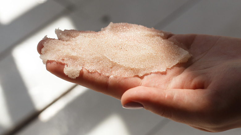 exfoliating scrub in hand