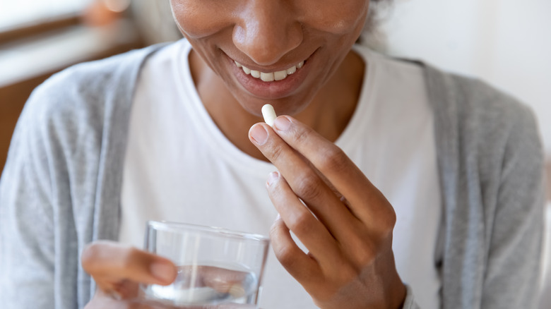 woman taking pills