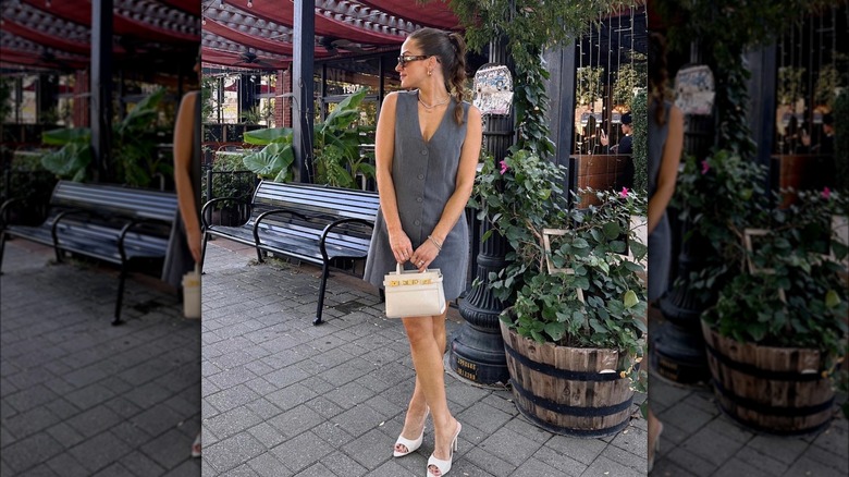 Woman wearing sleeveless suit dress