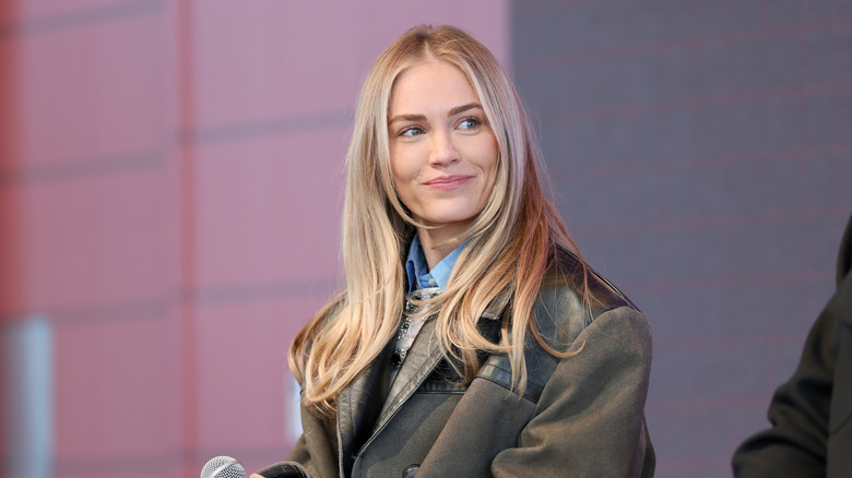 Michelle Randolph smiles while on stage for a panel interview