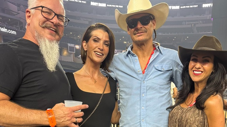 Kid Rock and Lauren Boebert posing for a cozy photo with Dana and Chris Loesch