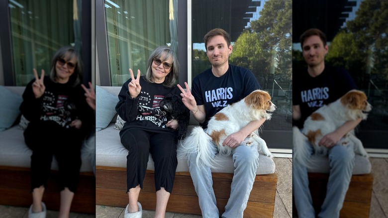 Sally Field and Sam Greisman posing together with a dog while wearing shirts supporting Kamala Harris and Tim Walz