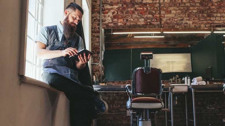 An annoyed hairstylist waiting for clients.
