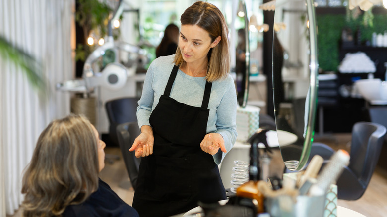 A client talking to their hairstylist in the salon.
