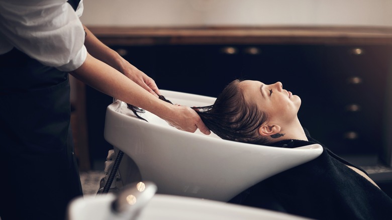 Woman getting her hair washed at a salon