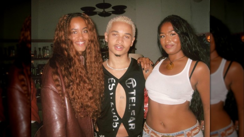 Malia and Sasha Obama with Destin Conrad, with Malia in a white crop top