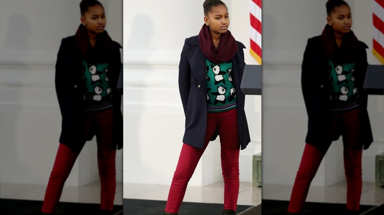 Sasha Obama wearing red tights and a blue coat at Thanksgiving 2013