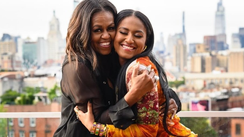 Michelle Obama smiles with her daughter Sasha Obama