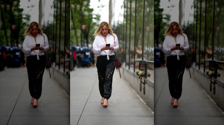 woman wearing ripped satin pants