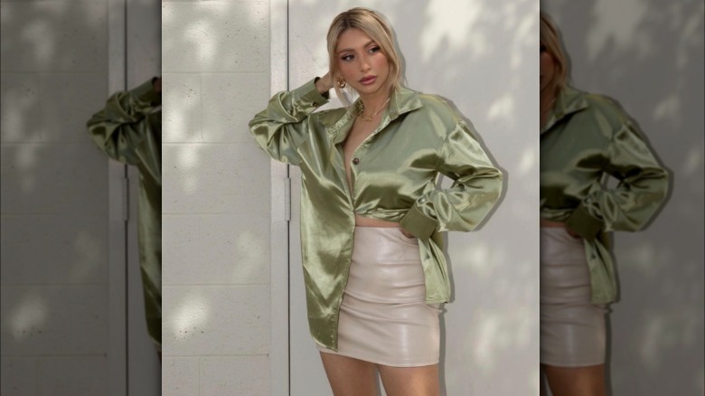 A woman wearing a satin button-up