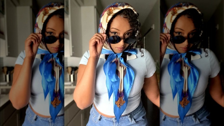 A woman wearing a satin scarf