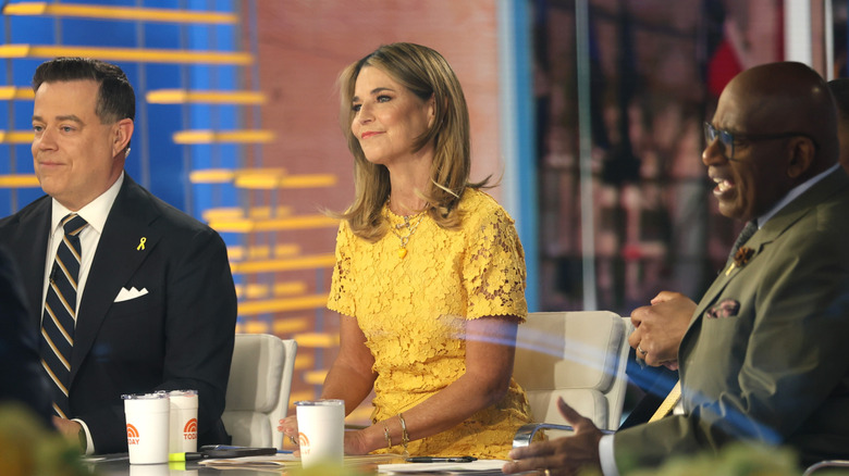 Carson Daly, Savannah Guthrie, and Al Roker sit at the Today Show table