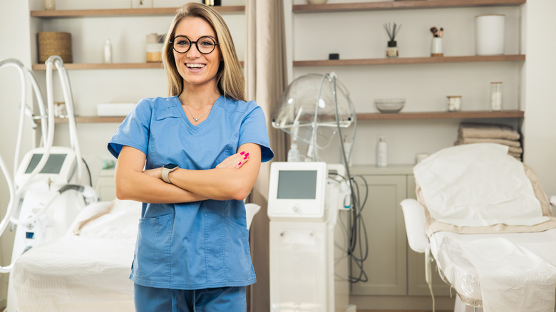smiling esthetician in clinic