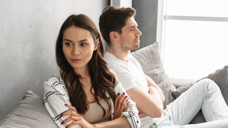 Woman angry, facing away from man