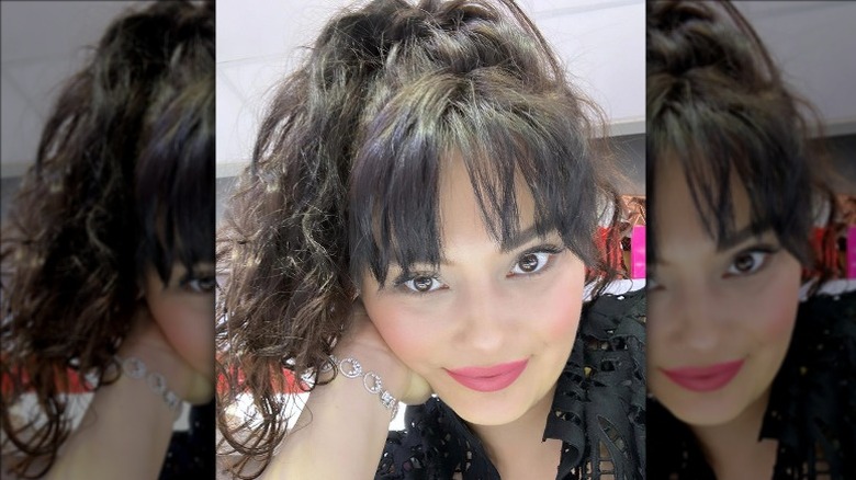 woman with see-through bangs and a high ponytail